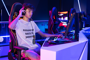 
                  
                    Boy playing video game wearing Reggae Me Back To Jamaica  White T-Shirt
                  
                